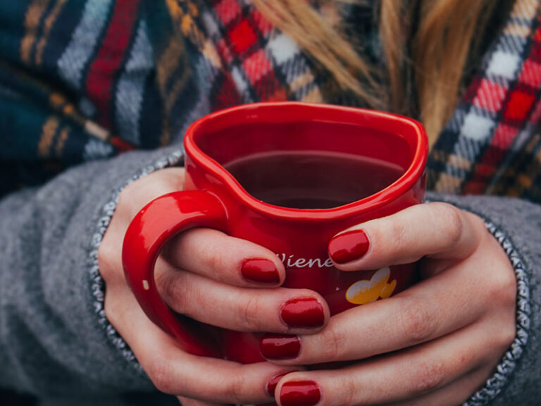 Person hugging a mug