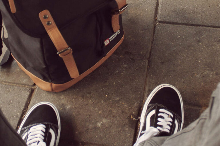 Feet next to a bag