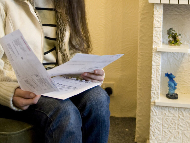 Person reading letter on chair