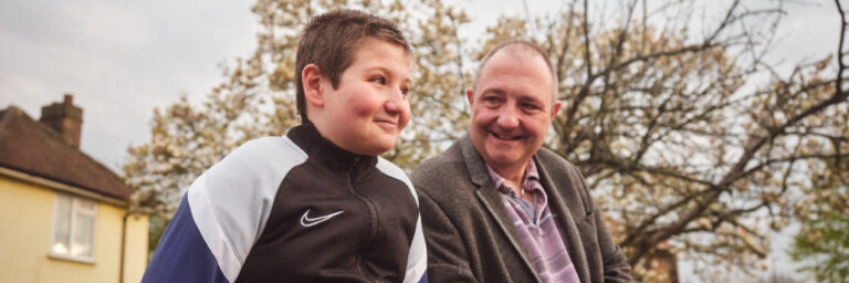 Older person with youngster smiling