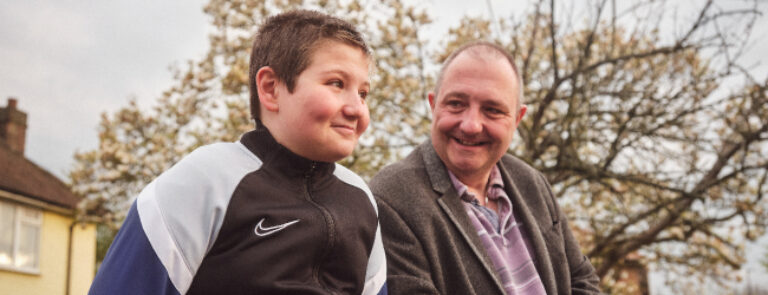 Older person with youngster smiling