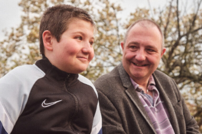 Older person with youngster smiling